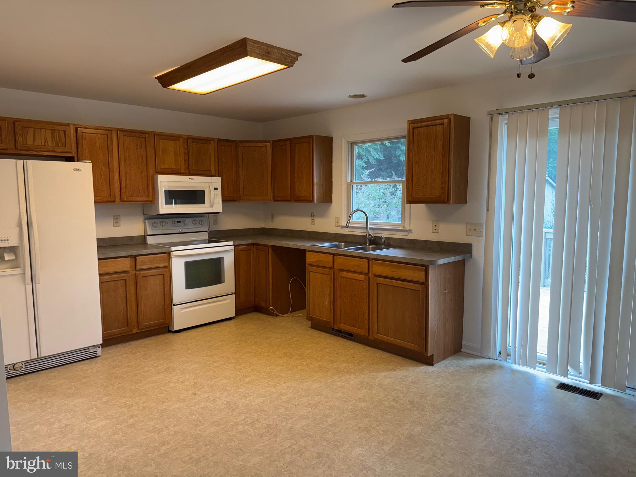 113 Boyce Mill Road Greensboro, MD 21639 - Photo 10 of 23 a kitchen with stainless steel appliances granite countertop a stove sink and refrigerator