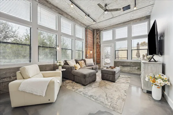 a living room with furniture and a flat screen tv