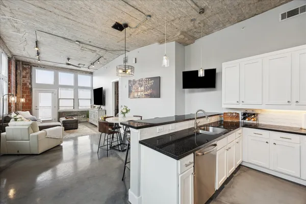 a kitchen that has a sink and a stove top oven