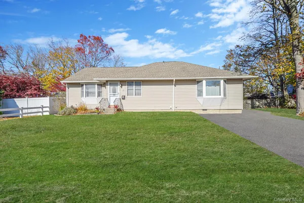 a front view of a house with a garden and yard