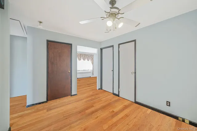 a view of empty room with wooden floor