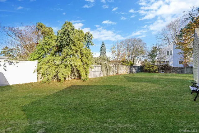 a view of a field of grass and trees