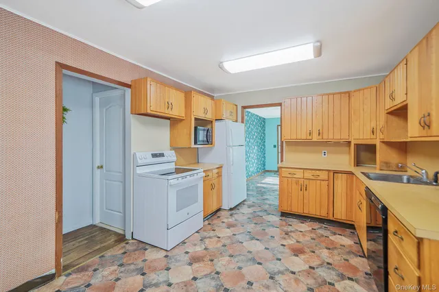 a kitchen with a stove top oven cabinets and a refrigerator