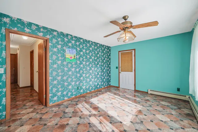 a view of a hallway with a chandelier fan and closet