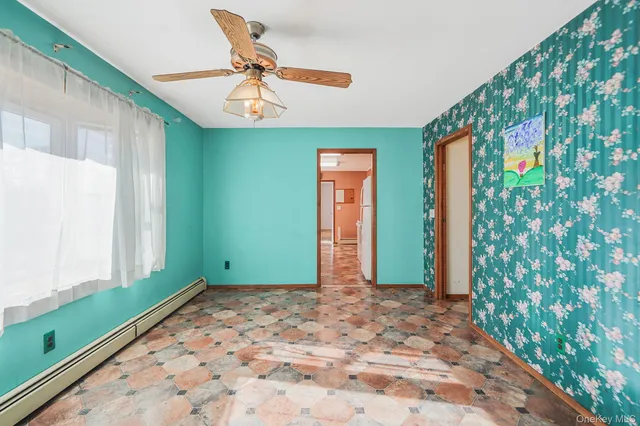 a view of a big room with a windows and a chandelier