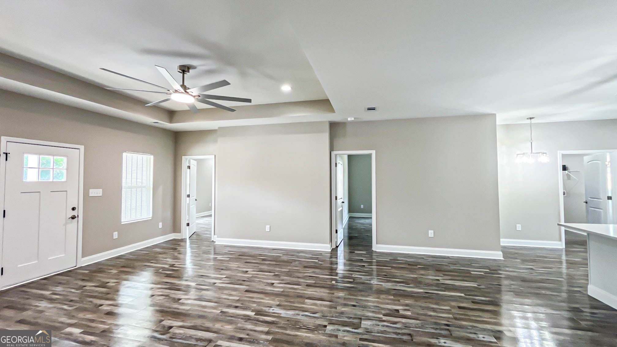 2011 Griffin Road Macon, GA 31216 - Photo 9 of 64 an empty room with wooden floor and ceiling fan