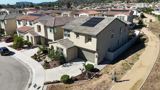 an aerial view of a house with a yard