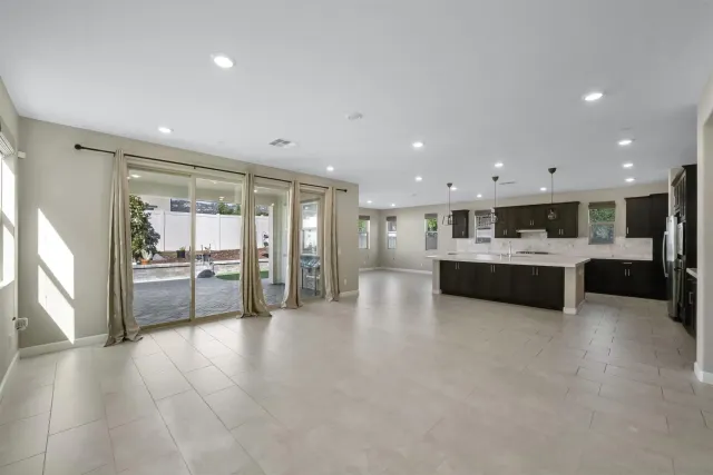 a kitchen with kitchen island a counter top space cabinets and stainless steel appliances