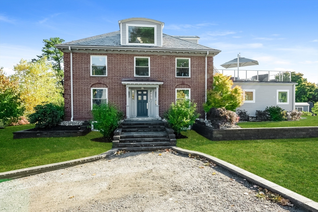 a front view of a house with a garden