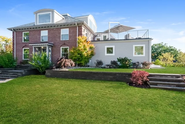 a front view of a house with a garden