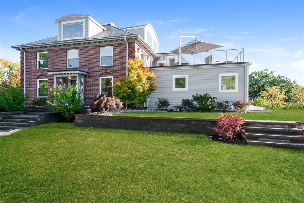 2-4 Evergreen Avenue Newton, MA 02466 - Photo 2 of 41 a front view of a house with a garden