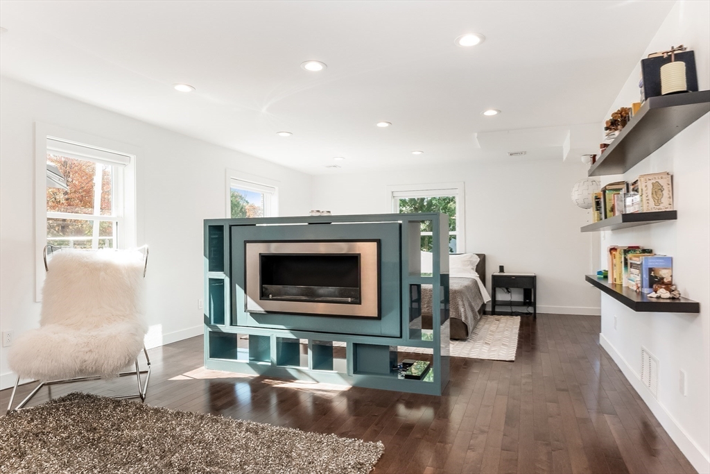 2-4 Evergreen Avenue Newton, MA 02466 - Photo 21 of 41 a living room with furniture a flat screen tv and a fireplace