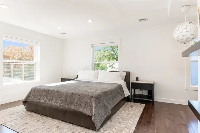 a bedroom with furniture and a flat screen tv