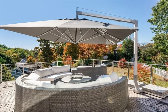 a view of a patio with couches table and chairs and potted plants