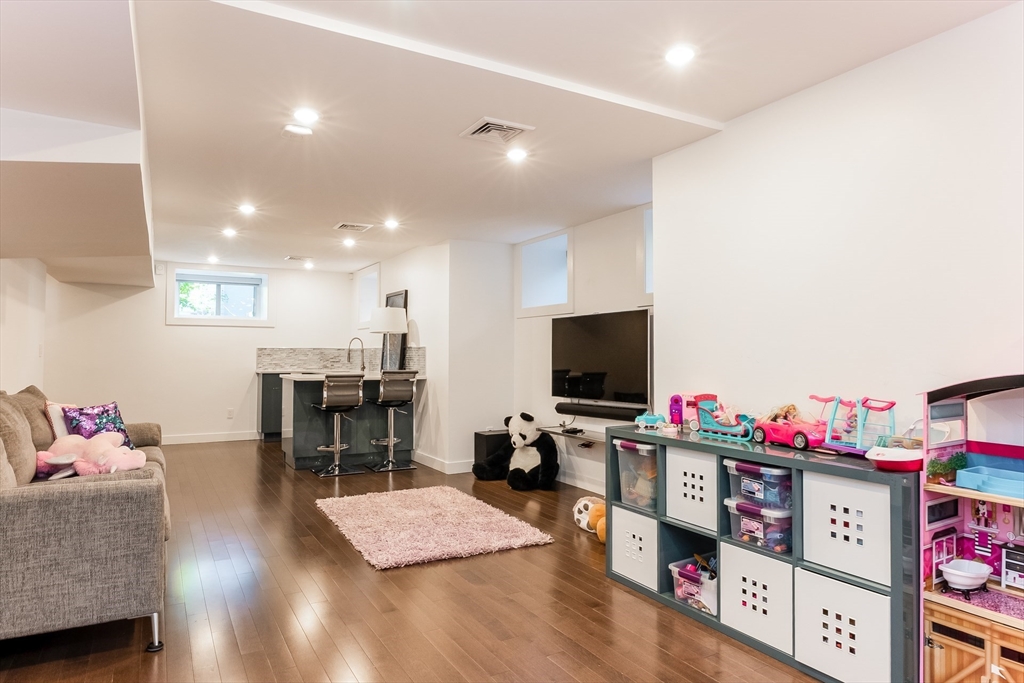 2-4 Evergreen Avenue Newton, MA 02466 - Photo 35 of 41 a living room with furniture and a flat screen tv