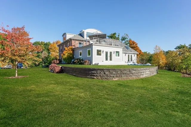 a front view of a house with a garden
