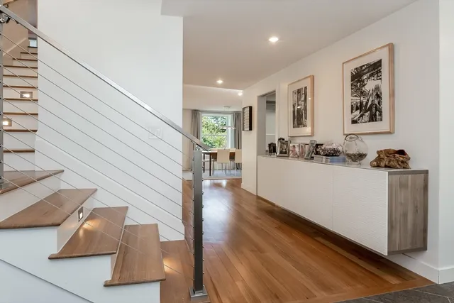 a view of a living room with furniture and wooden floor