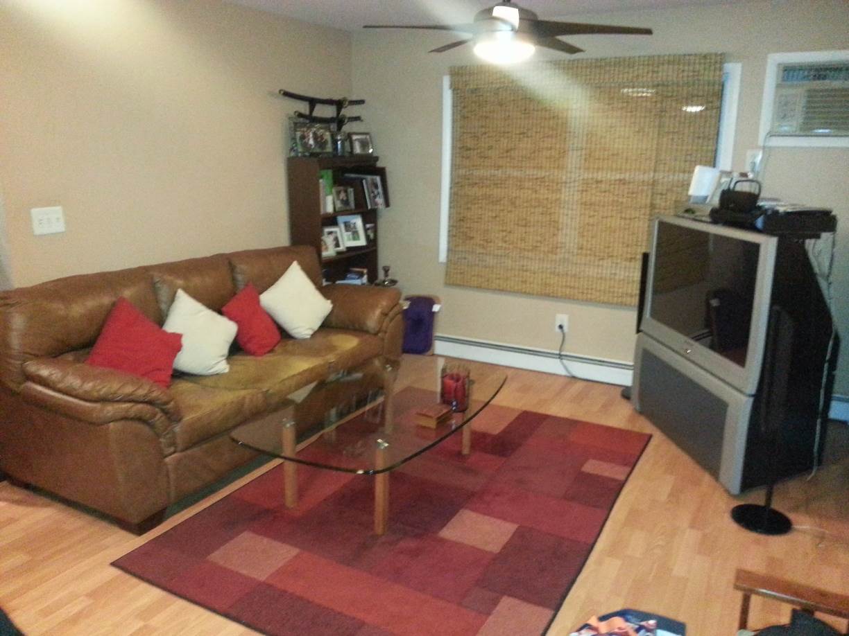 127 68th Street, Unit 14 Guttenberg, NJ 07093 - Photo 1 of 1 a living room with furniture and a rug