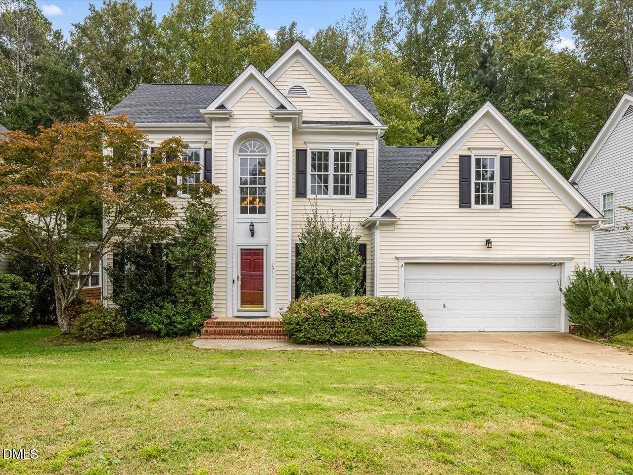 1311 Pendula Path Apex, NC 27502 - Photo 1 of 30 a view of a yard in front of a house with plants and large trees