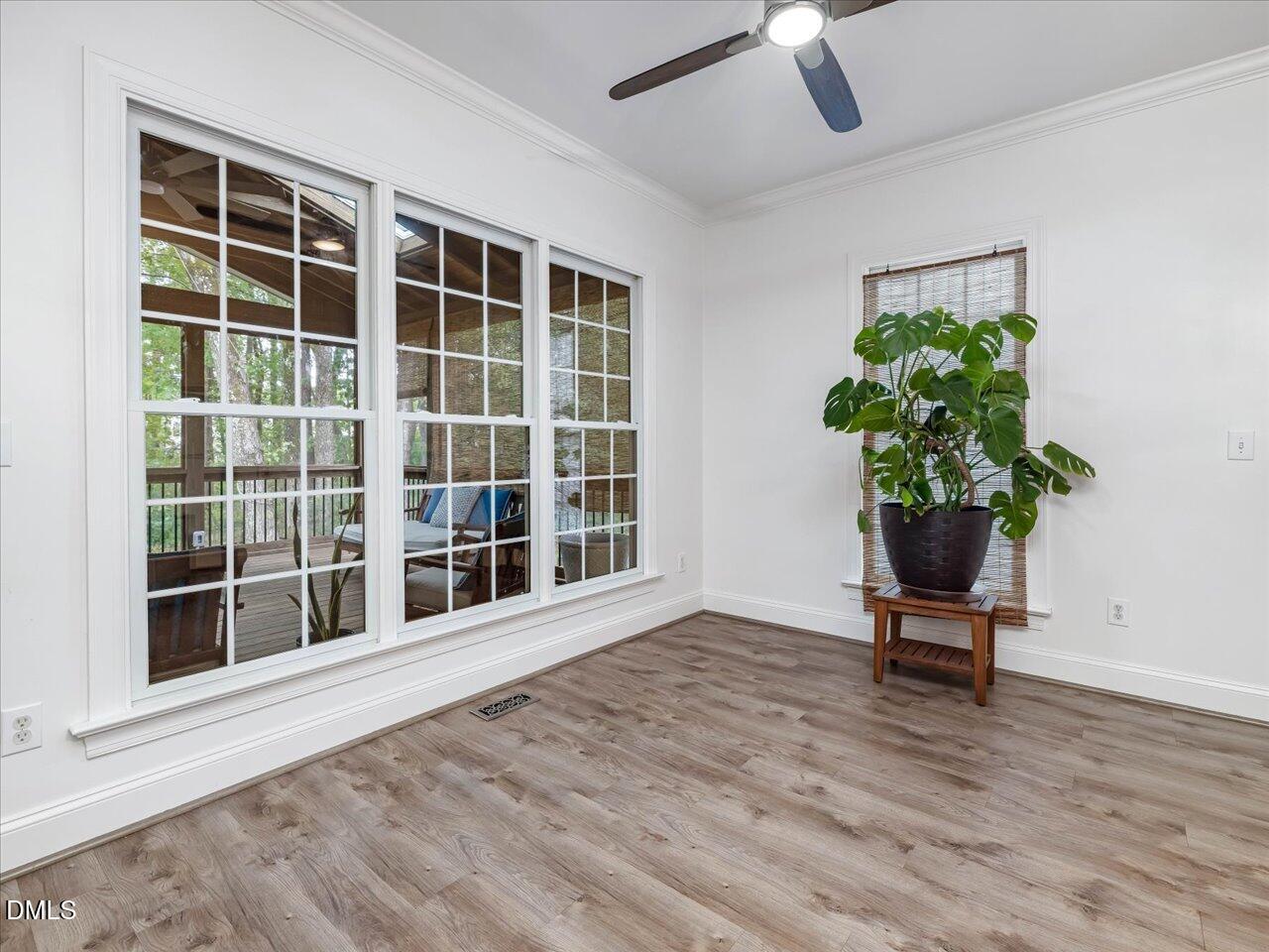 1311 Pendula Path Apex, NC 27502 - Photo 13 of 30 a view of a room with wooden floor and a potted plant