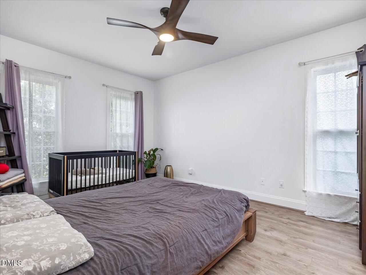 1311 Pendula Path Apex, NC 27502 - Photo 14 of 30 a bedroom with a bed and a window