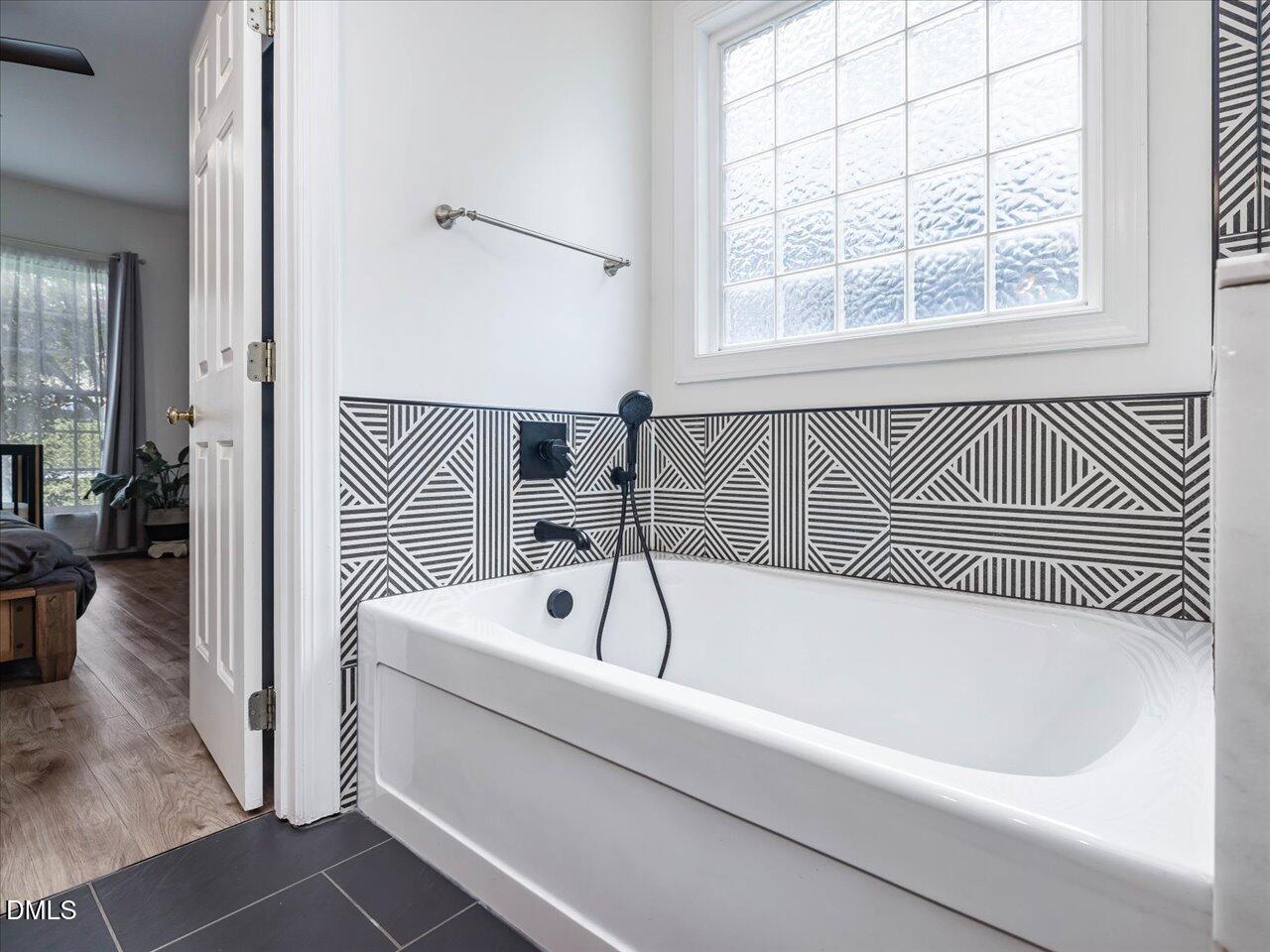 1311 Pendula Path Apex, NC 27502 - Photo 16 of 30 a bathroom with a bathtub and a shower