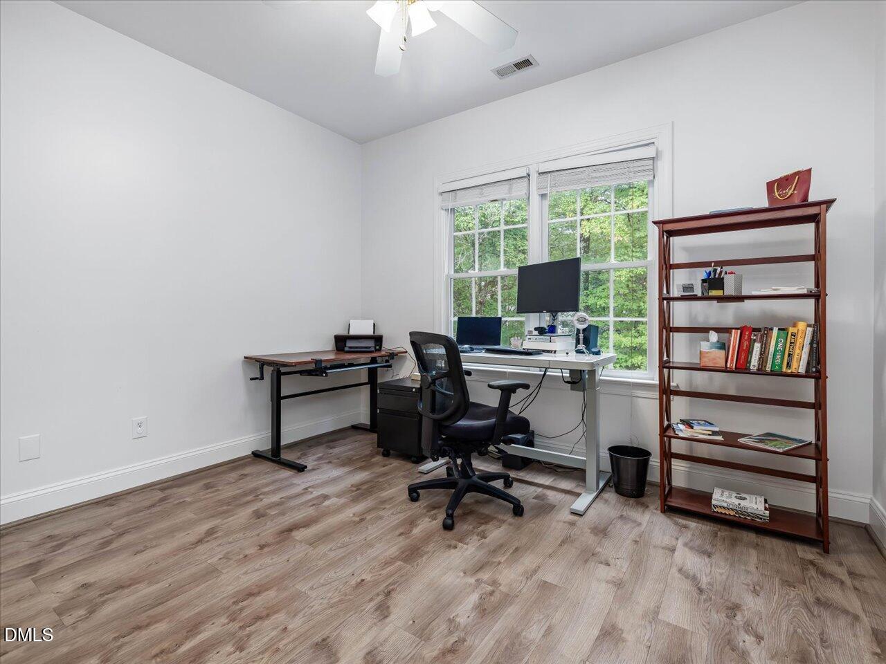 1311 Pendula Path Apex, NC 27502 - Photo 22 of 30 a view of a workspace with furniture and a window