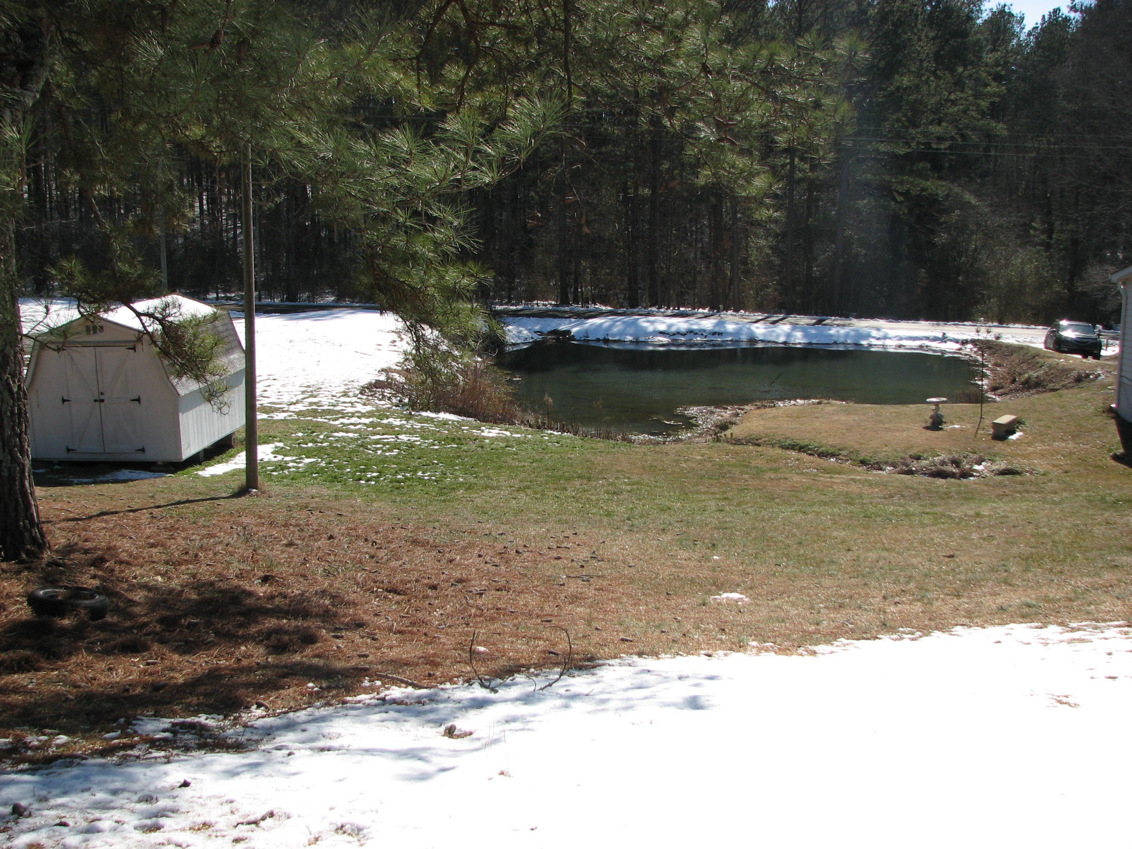 .93 acre lot with pond & outbuilding