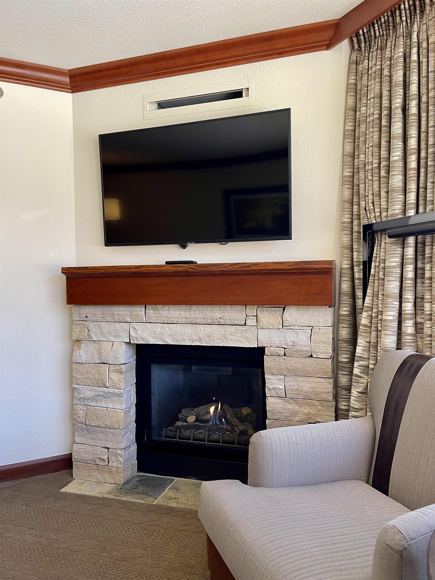 400 Resort Road, Unit 242 244 Olympic Valley, CA 96146 - Photo 6 of 28 a living room with furniture a fireplace and a flat screen tv
