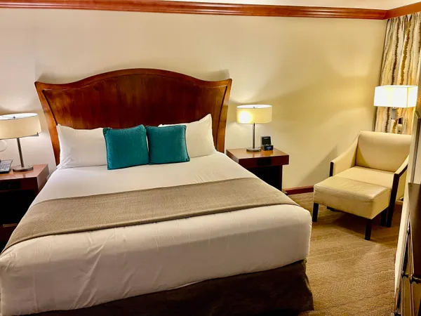 a bed sitting in a bedroom next to a lamp