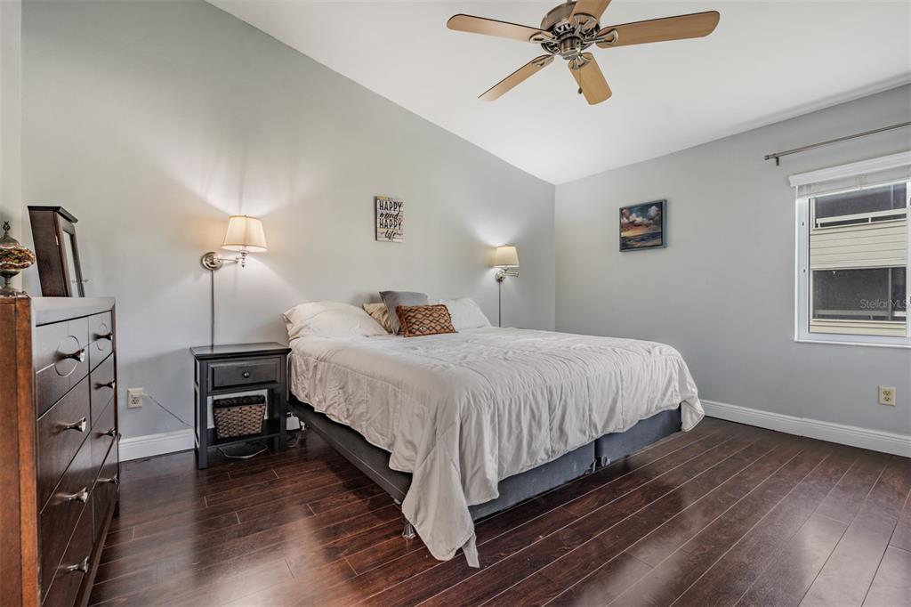 637 Drake Lane North Dunedin, FL 34698 - Photo 16 of 43 a bedroom with a bed and a chandelier