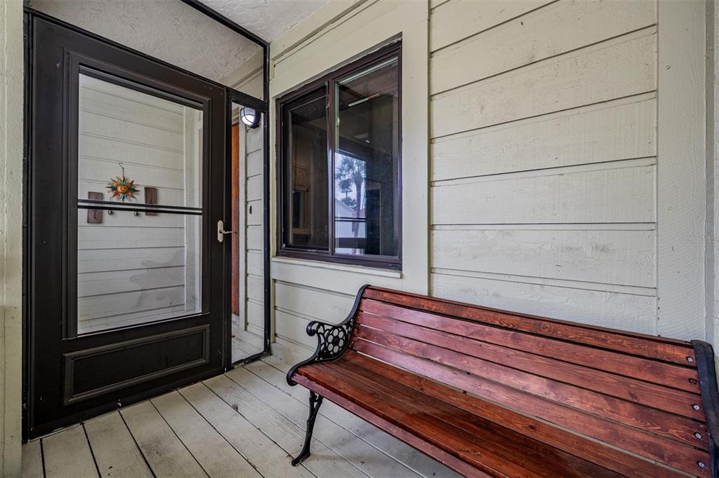 637 Drake Lane North Dunedin, FL 34698 - Photo 2 of 43 a bench sitting in front of door