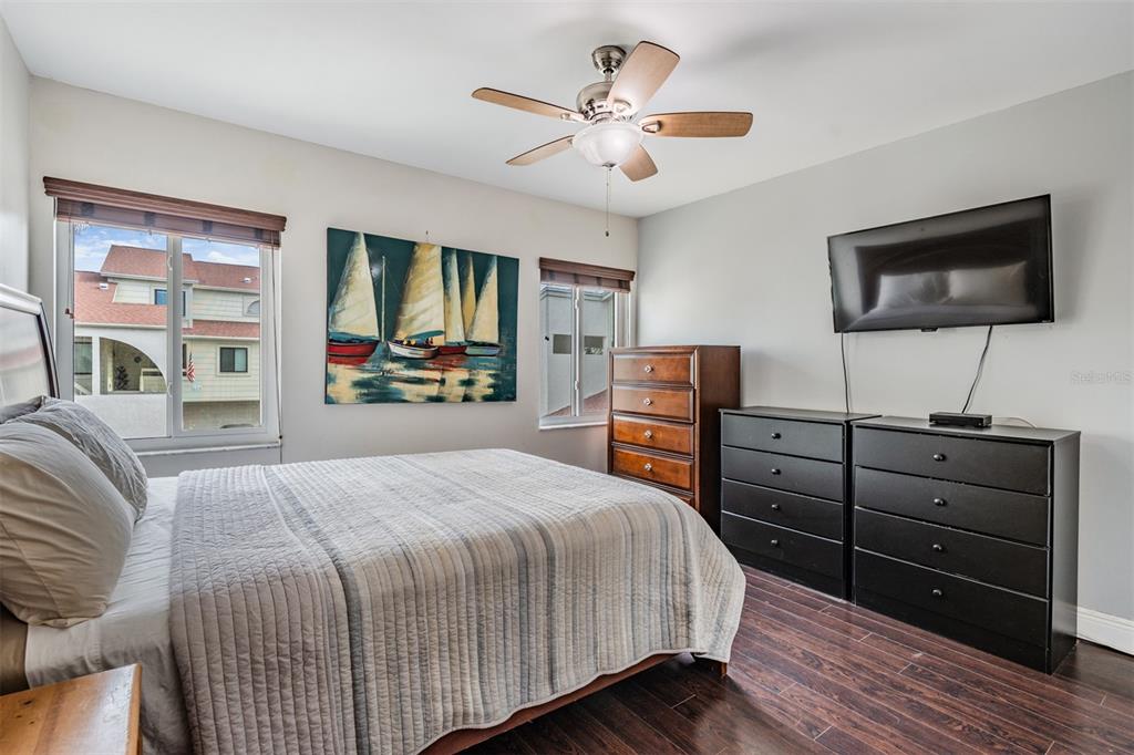 637 Drake Lane North Dunedin, FL 34698 - Photo 21 of 43 a bedroom with a bed and wooden floor