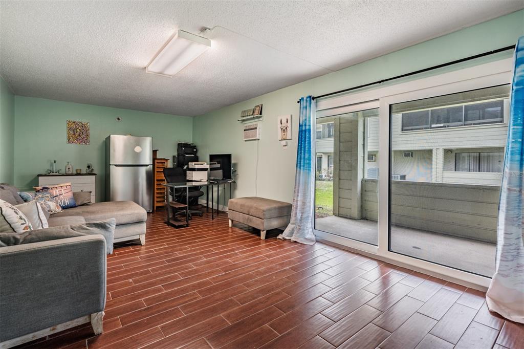 637 Drake Lane North Dunedin, FL 34698 - Photo 27 of 43 a living room with furniture a large window and stainless steel appliances
