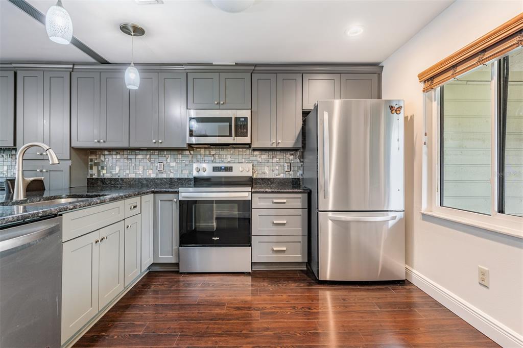 637 Drake Lane North Dunedin, FL 34698 - Photo 5 of 43 a kitchen with stainless steel appliances a refrigerator sink and cabinets