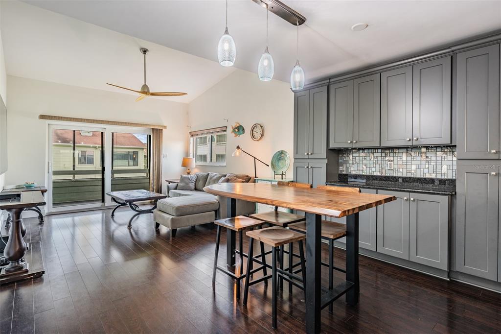 637 Drake Lane North Dunedin, FL 34698 - Photo 10 of 43 a very nice looking kitchen with a table chairs stove and wooden floor
