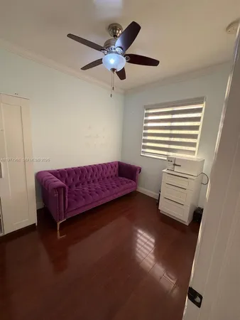 a bedroom with a bed and a ceiling fan