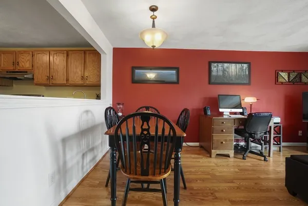 a view of a dining room with furniture and chandelier