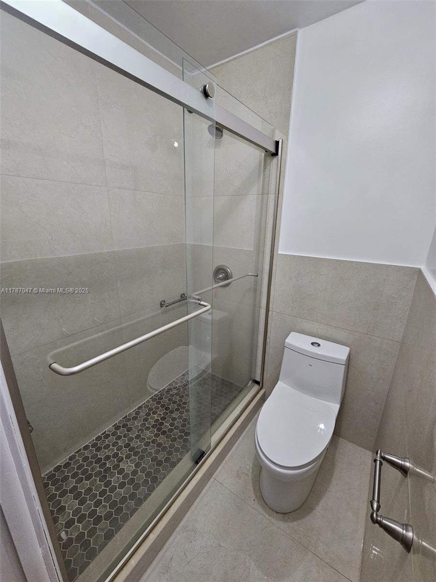 13745 Southwest 84th Street, Unit A Miami, FL 33143 - Photo 7 of 16 a bathroom with a toilet and a shower