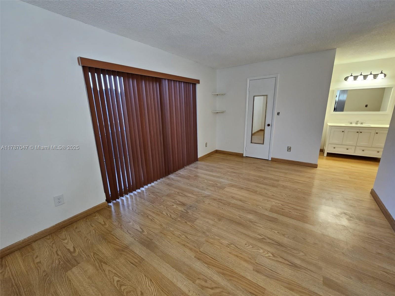 13745 Southwest 84th Street, Unit A Miami, FL 33143 - Photo 8 of 16 a view of a room with wooden floor
