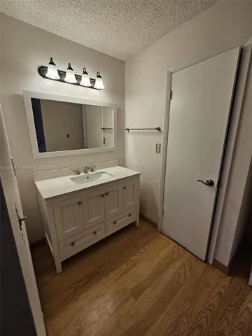 a bathroom with a sink vanity and mirror