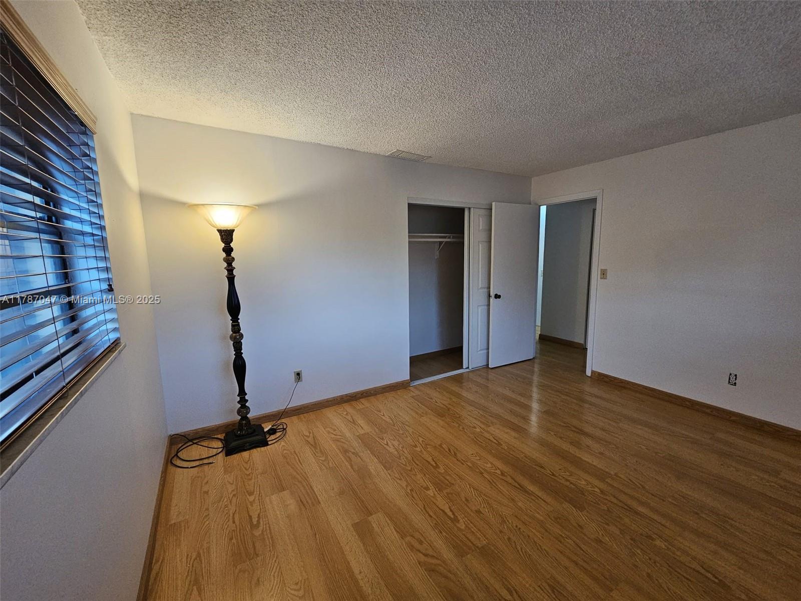 13745 Southwest 84th Street, Unit A Miami, FL 33143 - Photo 10 of 16 a view of empty room with wooden floor