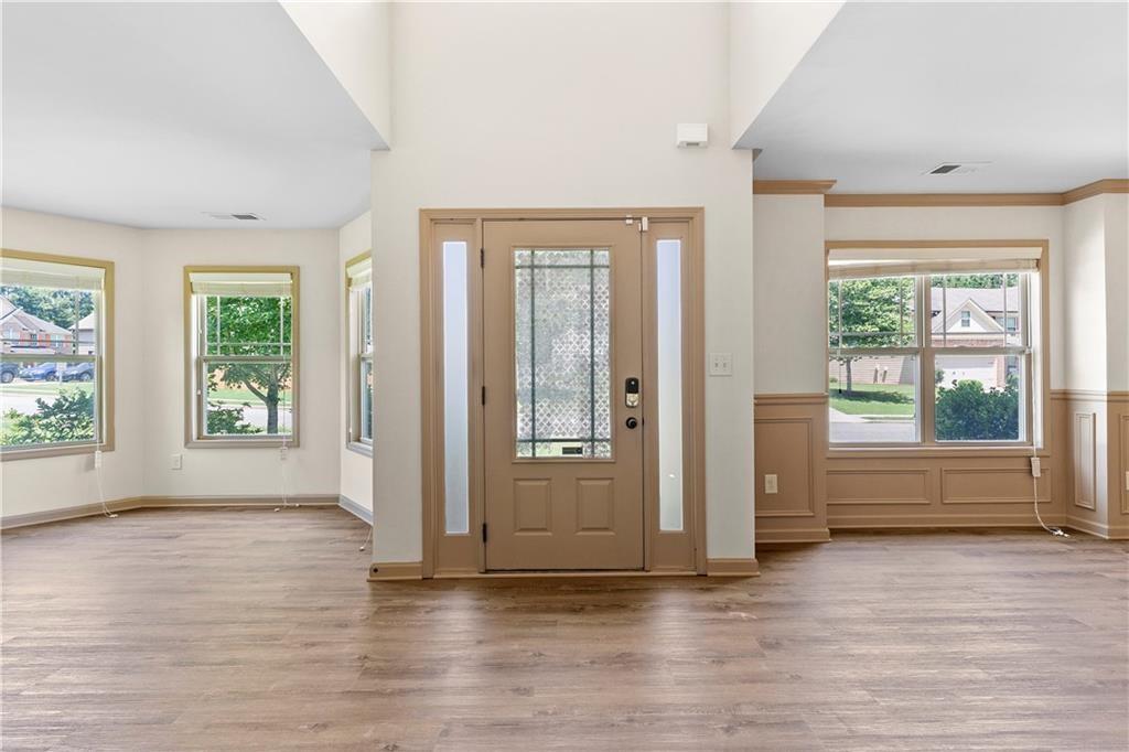 1492 Station Ridge Court Southeast Lawrenceville, GA 30045 - Photo 12 of 50 an empty room with wooden floor and windows