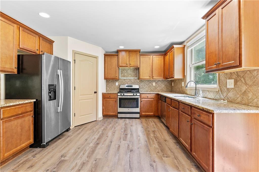 1492 Station Ridge Court Southeast Lawrenceville, GA 30045 - Photo 22 of 50 a kitchen with stainless steel appliances a refrigerator sink and cabinets
