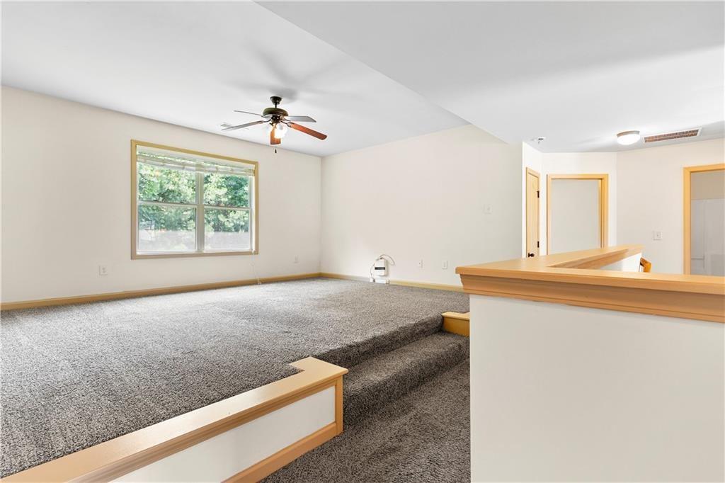 1492 Station Ridge Court Southeast Lawrenceville, GA 30045 - Photo 28 of 50 a living room with a bed furniture and a window
