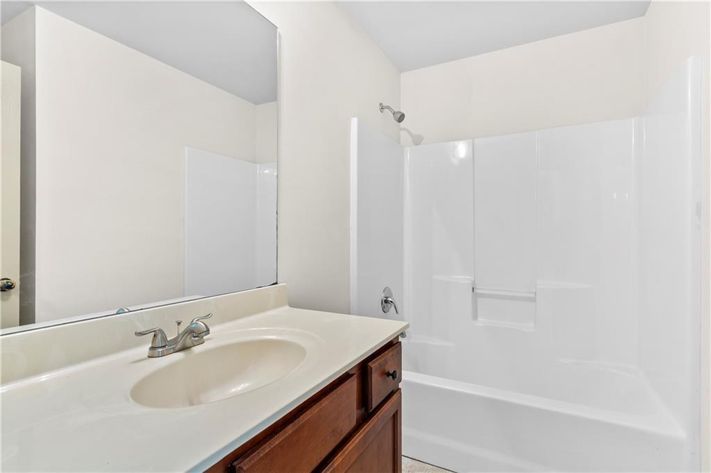 1492 Station Ridge Court Southeast Lawrenceville, GA 30045 - Photo 31 of 50 a bathroom with a sink and a mirror