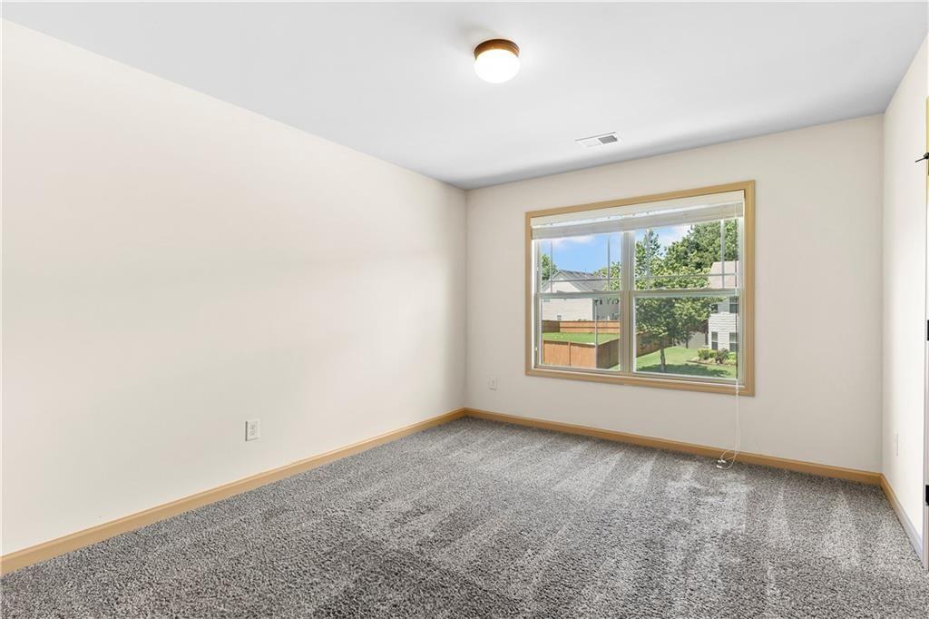 1492 Station Ridge Court Southeast Lawrenceville, GA 30045 - Photo 35 of 50 an empty room with windows