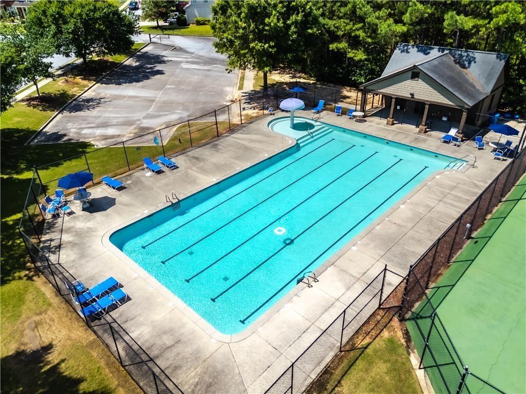 1492 Station Ridge Court Southeast Lawrenceville, GA 30045 - Photo 48 of 50 a view of a backyard with a patio and fire pit