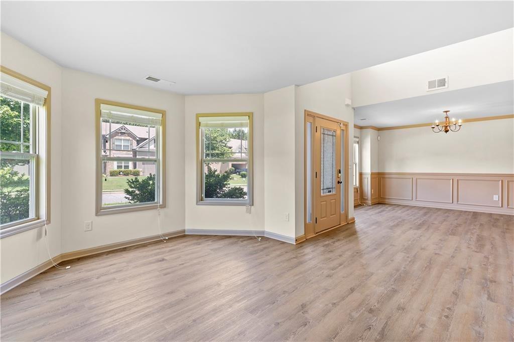 1492 Station Ridge Court Southeast Lawrenceville, GA 30045 - Photo 8 of 50 an empty room with wooden floor and windows