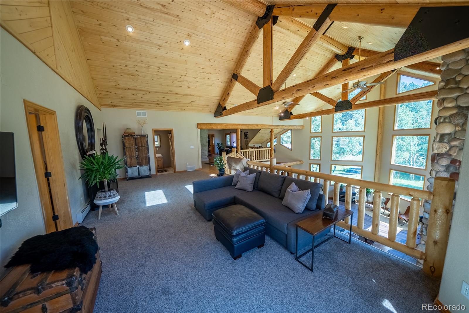 417 Witter Gulch Road Evergreen, CO 80439 - Photo 11 of 39 a living room with furniture and a large window